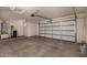 Bright garage featuring an automatic door, water heater, and storage space at 12221 W Locust Ln, Avondale, AZ 85323