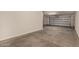 Spacious garage with smooth concrete flooring and an automatic door for easy parking at 12221 W Locust Ln, Avondale, AZ 85323