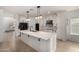 Spacious kitchen featuring white cabinets, large island, and modern stainless appliances at 12221 W Locust Ln, Avondale, AZ 85323