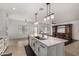 Spacious kitchen with white cabinets, large island with black modern faucet at 12221 W Locust Ln, Avondale, AZ 85323