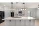Gorgeous renovated kitchen featuring large center island with modern pendant lights at 12221 W Locust Ln, Avondale, AZ 85323