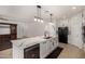 Open concept kitchen with large island, stainless dishwasher and undermount sink at 12221 W Locust Ln, Avondale, AZ 85323