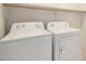 Bright laundry room featuring an Amana washer and dryer set for convenient chores at 12221 W Locust Ln, Avondale, AZ 85323