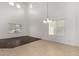 Bright living room with vaulted ceiling, light paint, and tile flooring at 12221 W Locust Ln, Avondale, AZ 85323