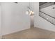 Bright living room with high ceilings, tile floors, and a staircase at 12221 W Locust Ln, Avondale, AZ 85323