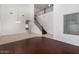 Spacious living room with high ceilings, tile floors, and a staircase at 12221 W Locust Ln, Avondale, AZ 85323