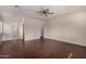 Bright main bedroom with dark wood-look floors and ceiling fan fixture at 12221 W Locust Ln, Avondale, AZ 85323