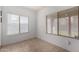 Comfortable room featuring two windows with horizontal blinds at 12221 W Locust Ln, Avondale, AZ 85323