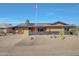 Charming single-story home with desert landscaping, solar panels and an American flag at 13202 W Flagstone Ct, Sun City West, AZ 85375