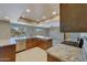 Bright kitchen with granite countertops, stainless steel appliances, and an island overlooking the pool at 13202 W Flagstone Ct, Sun City West, AZ 85375