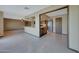 Open living space with tile flooring, a ceiling fan, and a kitchen with granite countertops in the background at 13202 W Flagstone Ct, Sun City West, AZ 85375