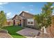 This home has a cozy backyard with artificial grass, a covered patio, and desert landscaping at 13218 W Crimson Ter, Peoria, AZ 85383