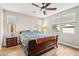 Comfortable bedroom features a ceiling fan, wood floors, and natural light through the windows at 13218 W Crimson Ter, Peoria, AZ 85383