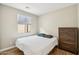 Simple bedroom with a bed, dresser, wood floors, and a window with natural light at 13218 W Crimson Ter, Peoria, AZ 85383