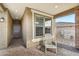 Cozy front porch seating area with neutral tones and a brick-paved floor creates an inviting outdoor space at 13218 W Crimson Ter, Peoria, AZ 85383