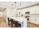 Modern kitchen featuring a center island with quartz countertops, pendant lighting, and stainless steel appliances at 13218 W Crimson Ter, Peoria, AZ 85383
