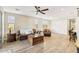 Comfortable living room with plush leather seating, wood floors, and stylish accent pieces, with view into kitchen at 13218 W Crimson Ter, Peoria, AZ 85383