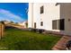 Large, grassy backyard with exterior AC units, and a view of the house at 1478 E Spur Ave, Gilbert, AZ 85296