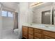 A well-lit bathroom features a double sink vanity and a shower-tub combo at 1478 E Spur Ave, Gilbert, AZ 85296