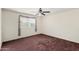A cozy bedroom with plush carpet and a ceiling fan for added comfort at 1478 E Spur Ave, Gilbert, AZ 85296