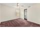 This secondary bedroom features neutral walls, carpet flooring, and a sliding closet with plentiful storage at 1478 E Spur Ave, Gilbert, AZ 85296