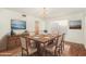 Traditional dining room with seating for eight, decorative chandelier and wood floors at 1478 E Spur Ave, Gilbert, AZ 85296