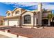 Attractive two-story home boasting a three-car garage and well-kept desert landscaping at 1478 E Spur Ave, Gilbert, AZ 85296