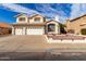 Charming two-story home with a three-car garage and desert landscaping under a sunny sky at 1478 E Spur Ave, Gilbert, AZ 85296