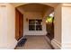 Covered front porch featuring double doors, neutral stucco, and a welcoming entryway at 1478 E Spur Ave, Gilbert, AZ 85296