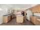 Bright kitchen with a central island, ample counter space, modern appliances, and custom cabinets at 1478 E Spur Ave, Gilbert, AZ 85296