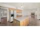 Eat-in kitchen features an island, stainless steel refrigerator, and ample wood cabinetry at 1478 E Spur Ave, Gilbert, AZ 85296