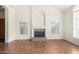 Bright living room with a large decorative fireplace feature and multiple windows for natural light at 1478 E Spur Ave, Gilbert, AZ 85296