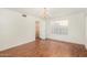 Spacious living room featuring hardwood floors, white walls, and a chandelier at 1478 E Spur Ave, Gilbert, AZ 85296