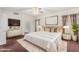 Cozy main bedroom with ensuite bath, plush carpeting, and a ceiling fan at 1478 E Spur Ave, Gilbert, AZ 85296