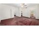 The spacious main bedroom includes a ceiling fan, neutral walls, and arched doorways to the walk-in closet and bathroom at 1478 E Spur Ave, Gilbert, AZ 85296