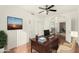 Home office with a work desk, ceiling fan, and an open entry to the dining room at 1478 E Spur Ave, Gilbert, AZ 85296