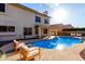 Backyard with pool, lounge chairs, and covered patio for outdoor relaxation at 1478 E Spur Ave, Gilbert, AZ 85296