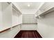 This walk-in closet is equipped with several shelves and rods for the storage of clothing items at 1478 E Spur Ave, Gilbert, AZ 85296