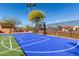 View of community basketball court surrounded by desert landscaping and mature trees at 1500 N Markdale -- # 8, Mesa, AZ 85201
