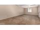 Spacious bedroom with neutral carpet, a ceiling fan, and natural light from the window at 1500 N Markdale -- # 8, Mesa, AZ 85201