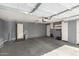 Spacious garage with ample storage, lighting, and gray painted walls at 1500 N Markdale -- # 8, Mesa, AZ 85201