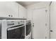 Laundry room with washer, dryer, white cabinets and a door leading outside at 1500 N Markdale -- # 8, Mesa, AZ 85201