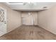Large carpeted living room with high ceilings, a ceiling fan, and a front entry door at 1500 N Markdale -- # 8, Mesa, AZ 85201