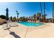 A welcoming community pool with plenty of seating, umbrellas, and desert landscaping at 1500 N Markdale -- # 8, Mesa, AZ 85201