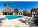 Serene community pool with a covered lounging area and comfortable lounge chairs at 1500 N Markdale -- # 8, Mesa, AZ 85201
