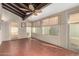 Enclosed sunroom with a ceiling fan, beamed ceiling, and terra cotta tile flooring at 1500 N Markdale -- # 8, Mesa, AZ 85201