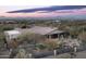 Desert home with a tile roof, covered patio, and a tranquil backyard with desert landscaping at 15123 E Monument Rd, Scottsdale, AZ 85262