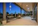 Serene covered patio with a fire pit and views of the landscaped backyard at 15123 E Monument Rd, Scottsdale, AZ 85262