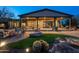 Tranquil backyard featuring a covered patio, fire pit, desert landscaping, and comfortable outdoor seating at 15123 E Monument Rd, Scottsdale, AZ 85262