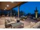 Expansive covered patio with comfortable seating and desert landscaping at 15123 E Monument Rd, Scottsdale, AZ 85262